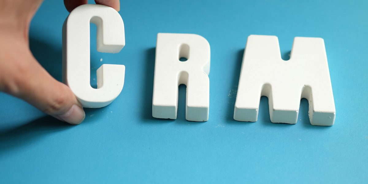 Hand arrange white letters as CRM